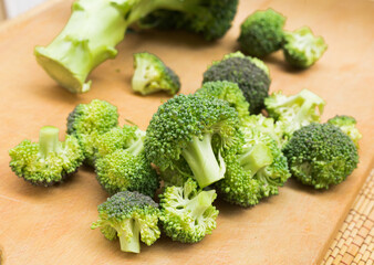resh appetizing broccoli inflorescences on wooden board