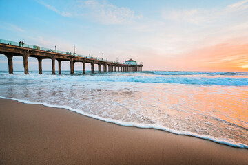 Manhattan beach pier at sunset, orange-pink sky with bright colors, beautiful landscape with ocean...