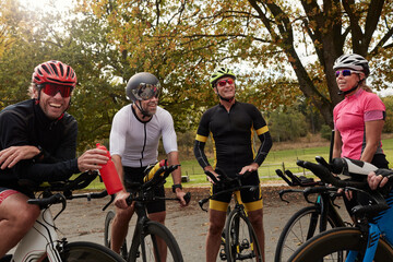 Smiling cyclists talking while resting