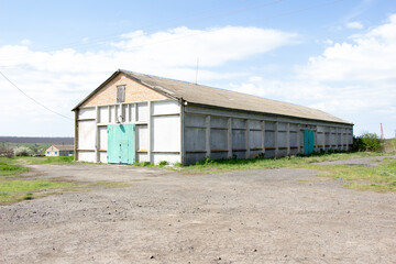 Fototapeta na wymiar New buildings and old buildings grain storage hangars in the countryside of Ukraine