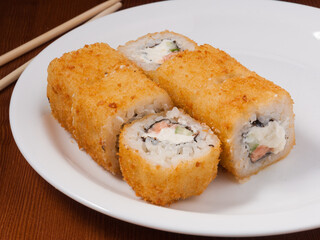 tempura sushi roll with salmon on a white plate