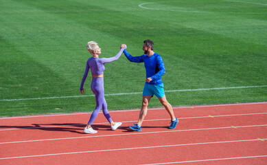 sport couple fitness partners celebrate team win with gesture of shake hand after exercising or...