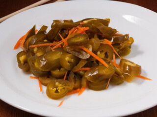 spicy pickled Korean jalapeno on a white plate