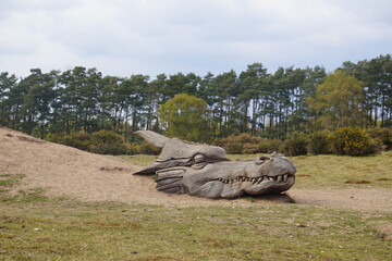 Dragon face wooden sculpture in West Stow Country Park © Paulina