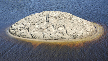 Sandy island in the riverbed.