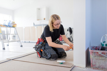 Female electrician renovating house