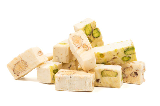 Italian torrone nougat candy blocks with almonds and pistachios isolated on white background