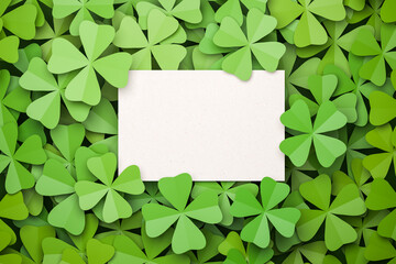 Cloverleaf background with an empty card for own text in the middle. All clovers are four-leafed....
