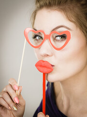 woman holds carnival accessories on stick