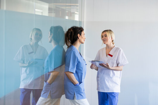 Female nurse and doctor talking in hospital