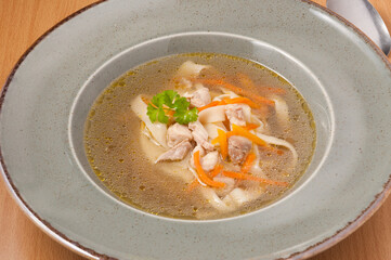 chicken soup with noodles and herbs. close up