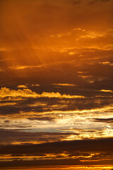 Golden sunset with clouds in the sky; color photo.