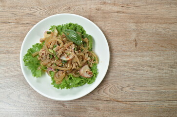 Thai spicy chop pork and slice skin salad with fresh vegetable on plate
