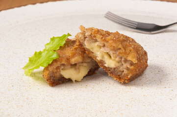 meat zrazy with cheese on a plate. close up