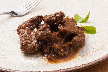 beef goulash decorated with herbs. close up