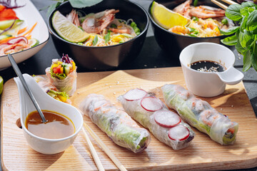 Fototapeta na wymiar fresh springrolls with vegetables and shrimps. a healthy dish of rice paper and fresh organic vegetables