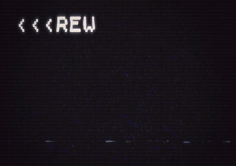 A fake screen capture with intentional distortion and noise, the blank screen of an old VHS player connected to a tv with the text REW (rewinding) at the top left corner. 