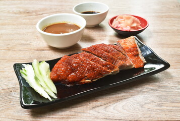 roasted duck meat and pickled ginger dipping sweet soy sauce on plate