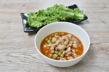 spicy boiled chicken with eggplant in coconut milk curry soup on bowl
