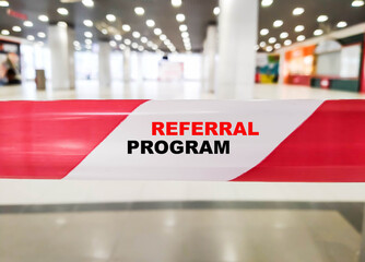 The concept of a referral program on a white-red ribbon. Referral program in modern closed business