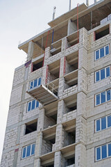 The facade of modern residential building under construction
