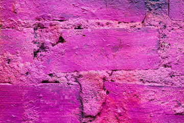 Purple and old brick wall. Close up view