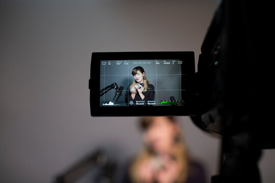 Female professional explaining through video recording on camera at office