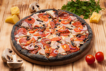 pepperoni pizza ham mushrooms on black dough