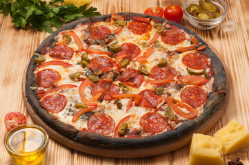 pizza with pepperoni and jalapenos on a black test