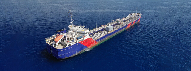 Aerial drone ultra wide panoramic photo of crude oil tanker carrier anchored in deep blue open ocean sea