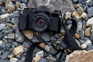 analog camera poised on stones