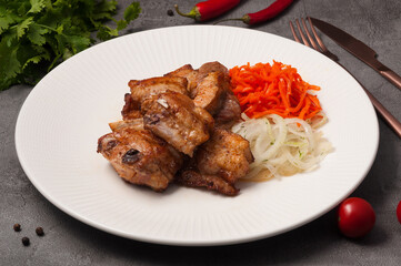 pork skewers on the bone with onions and carrots