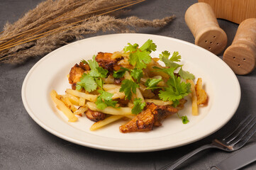 fried potatoes with chanterelles garnished with coriander