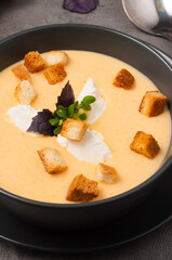 cheese soup with croutons, cream cheese decorated with Basil