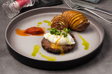steak with egg and potatoes with cheese in a restaurant