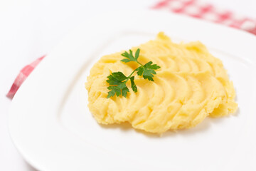 Airy delicious mashed potatoes on a white background