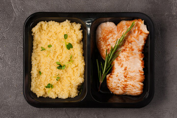 bulgur and pork chop in a container. Concept: ready food delivery