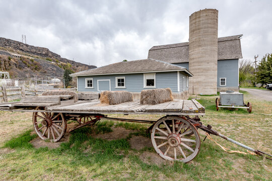 An old wooden horse drawn wagon at a dairy barn