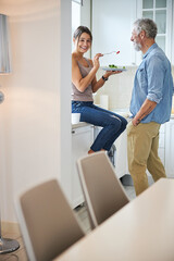 Positive brunette female person feeding her man