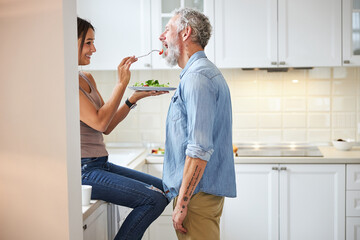 Close up of happy woman that feeding her partner