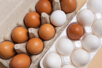 Brown and white eggs in cardboard boxes