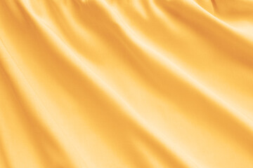 Yellow silk texture, abstract background luxury fabric with wavy folds