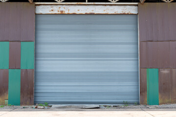 Obraz na płótnie Canvas Large gray metal shutter door for warehouse