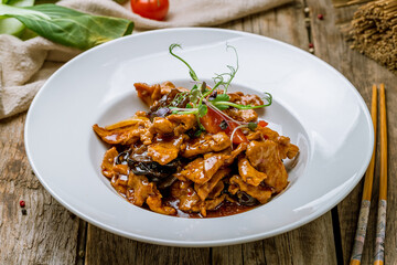 Sichuan Fried Pork, chinese cuisine on old wooden table