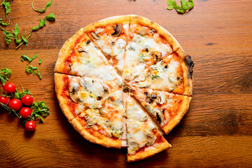 Italian pizza with cheese, arugula and mushrooms on wooden cutting board stock photo.
