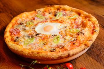 Italian pizza with cheese tomatoes, arugula and mushrooms on wooden cutting board stock photo.