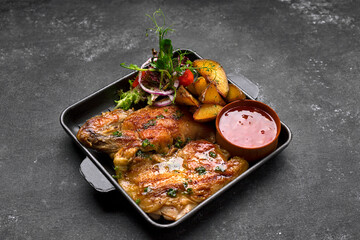 Fried chicken with crispy crust, potatoes and sauce