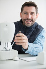 man repairing a sewing machine