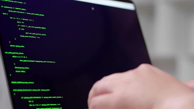 Close up hands of hacker rapidly typing code for hacking password internet online network. Screen monitor showing green coding run but display show error access denied. He angry and smash computer