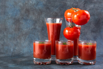 Tomato juice. Tomatoes and tomato juice in glasses. Detox. Healthy eating. Healthy foods on vintage background. High quality photo